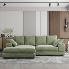 a living room with a large green couch