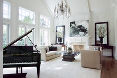 a living room filled with furniture and a piano