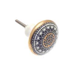 a white and gold knob with an ornate design on it's side, against a white background