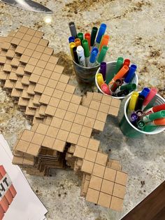 a table topped with lots of crafting supplies on top of a wooden cutting board