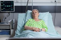 an older woman laying in a hospital bed