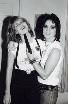 two women standing next to each other posing for the camera