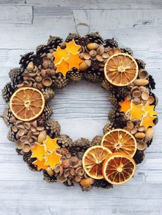 a wreath made out of pine cones, orange slices and nuts with stars on them