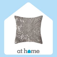 an image of a decorative pillow with the words at home written below it in blue and white