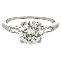 Simply Beautiful! Vintage Red Carpet TIFFANY & CO Art Deco Diamond Solitaire Platinum Ring. Centering a GIA Round Brilliant Cut Diamond, weighing approx. 1.66 Carat, I-SI2 with a Baguette Diamond on either side, approx. 0.12tcw. Hand crafted Platinum mounting. GIA certificate #2225460753. Ring size 5.5, we offer ring resizing. Ideal worn alone or as an alternative Engagement ring. More Beautiful in real time! Sure to be admired…Chic and Classic… illuminating your look with Timeless Beauty! Vintage Red Carpet, Vintage Tiffany, Alternative Engagement Rings, Tiffany And Co, Round Rings, Art Deco Diamond, Platinum Ring, Baguette Diamond, Gia Diamond