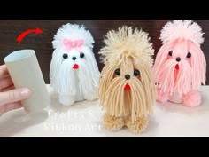 three small dogs made out of yarn sitting next to each other