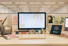 two computer monitors sitting on top of a desk next to each other in an office