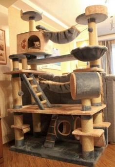 the cat tree is made out of wood and has several scratchings on top of it