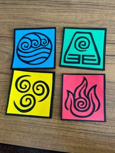 four different colored paper cut outs with symbols in the shape of fire, water and air