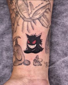 a person with a tattoo on their foot has a black cat in the middle of it