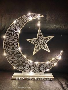 a lighted moon and star on a stand