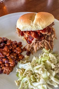 a pulled pork sandwich and coleslaw on a plate