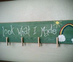 a wooden sign that says look what i made with clothes pegs on the wall