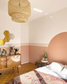 a bed room with a neatly made bed and a large mirror on the wall above it