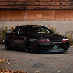 a black car parked in front of a building