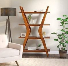 a living room filled with furniture and a potted plant on top of a wooden shelf