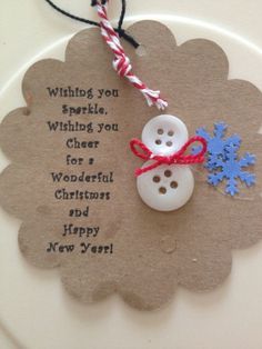 a snowman ornament hanging from a string on top of a paper plate