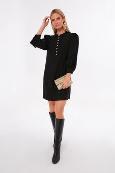 Versatile, on-trend, and classic, the Black Samantha Mini Dress is a must-have for fall and winter. This staple LBD features a quarter length button front placket, three-quarter length blouson sleeves, and a relaxed, but not oversized fit thatâll effortlessly take you from desk to drinks. We are pairing this chic, sophisticated number with boots and adding gold accessories for that extra touch of glam that every gal needs! Band collar Three-quarter length blouson sleeves Button cuffs Quarter l Tuckernuck Dress, Band Collar, Gold Accessories, Gold Buttons, Pullover Sweatshirts, Fall Trends, Fall Dresses, Fall And Winter, Three Quarter