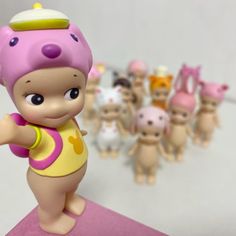 there is a small figurine with many little babies in the background