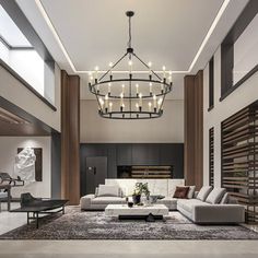 a modern living room with large chandelier and couches in the center area