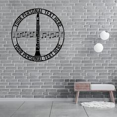 a clock on the side of a brick wall next to a bench and lamppost