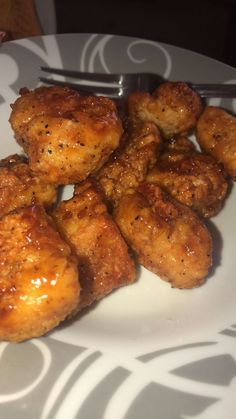 some fried food on a white plate with a fork