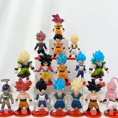 a group of dragon ball figurines sitting on top of a white table next to each other