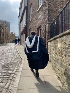 a person walking down a street with a large bag on his back