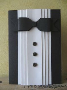 a black and white card with a bow tie on it's lapel cover