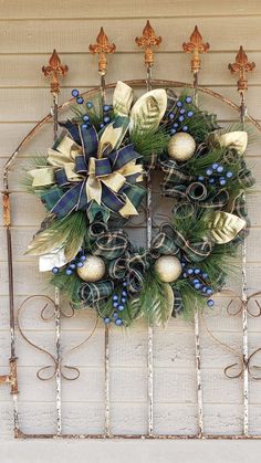 a christmas wreath hanging on the side of a building with bells and ornaments around it