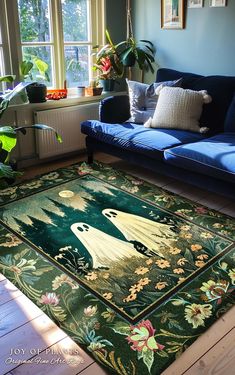 a living room with a blue couch and rug on the floor