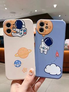 two phone cases with cartoon characters on them, one is blue and the other is white