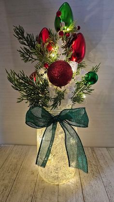 a vase filled with christmas decorations on top of a wooden table