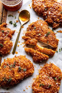 fried chicken cut in half and served on parchment paper next to jar of bbq sauce