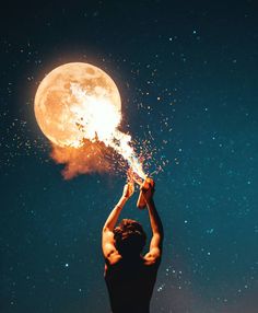 a man is holding the moon with his hands and reaching for it to fly through the air