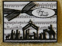 a black and white christmas card with musical notes on the sheet that says joy to the world