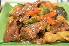 a green plate topped with beef and broccoli