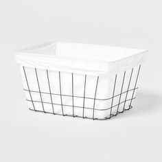 a white basket with black lines on the bottom and sides, sitting against a white background