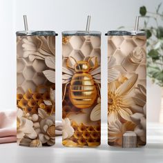 three tumbles with bees and flowers on them