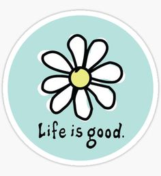 a white flower with the words life is good in black lettering on a blue circle