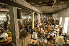 a room filled with lots of clutter and furniture in it's center aisle