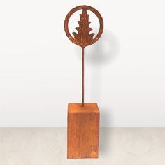 a wooden sculpture with a leaf on it