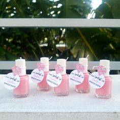 five pink nail polish bottles with labels on them