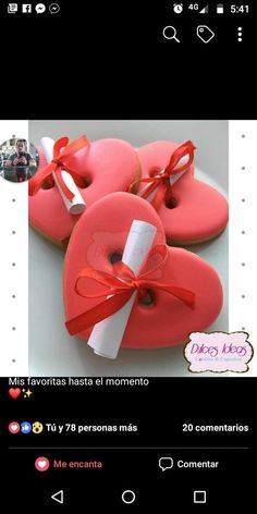 two heart shaped cookies with ribbon tied around the edges, on top of each other