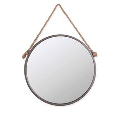 a round mirror hanging on a rope