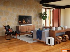 a living room filled with furniture and a painting on the wall