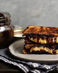 two grilled cheese sandwiches on a plate with jam