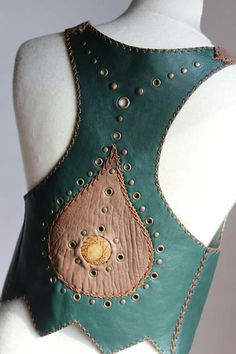 a woman's green leather corset with gold buttons