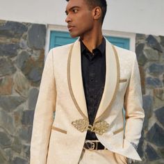 Ivory Paisley Pattern: This Stacy Adams Tuxedo Jacket Features A Timeless Ivory Paisley Pattern Fabric, Perfect For Any Formal Occasion. Gold Embellished Trim: The Jacket Is Finished With A Gold Embellished Trim, Adding A Subtle Yet Stylish Touch. Frog Closure: The Jacket Also Features A Frog Closure, Providing A Secure And Comfortable Fit. This Stacy Adams Tuxedo Jacket Is The Perfect Combination Of Style And Sophistication. Featuring A Timeless Ivory Paisley Pattern Fabric, Gold Embellished Trim, And Frog Closure, This Jacket Is Perfect For Any Formal Occasion. Crafted From Quality Materials, This Tuxedo Jacket Is Sure To Make A Statement. Classic Beige Outerwear For Wedding, Off White Tuxedo, Elegant Fitted Blazer For Wedding Guests, Beige Fitted Tuxedo For Wedding, Beige Fitted Wedding Tuxedo, Elegant Beige Wedding Suits, Elegant Beige Party Blazer, Beige Suit Collar Outerwear For Wedding, Elegant Gold Tuxedo With Notch Lapel