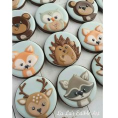 cupcakes decorated with frosting depicting animals